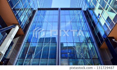 Bottom up view of  modern glass office building. Commercial real estate. New commercial office building in modern city. 131729487