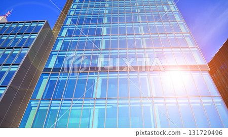Bottom up view of modern glass office building. Commercial real estate. New commercial office building in modern city. Bottom up view of modern glass office building. Commercial real estate. New commercial office building in modern city. 131729496