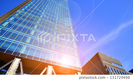 Bottom up view of modern glass office building. Commercial real estate. New commercial office building in modern city. Bottom up view of modern glass office building. Commercial real estate. New commercial office building in modern city. 131729498