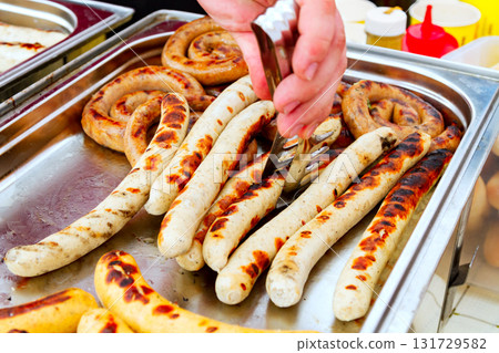Closeup shot of sausages on the metal tray 131729582