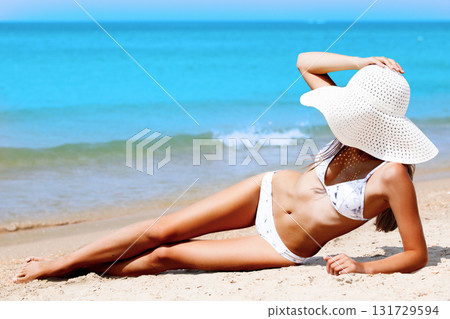 Slim woman on a beach. Summer holidays Slim woman on a beach. Summer holidays 131729594