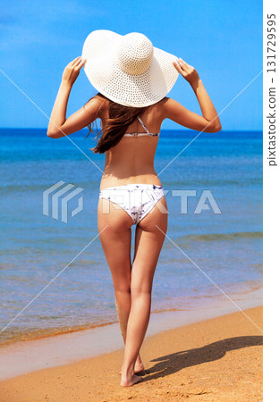 Slim woman on a beach. Summer holidays 131729595