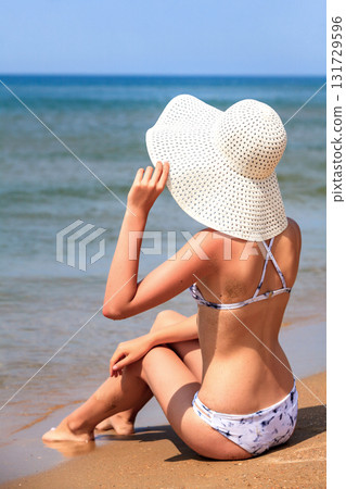 Slim woman on a beach. Summer holidays 131729596