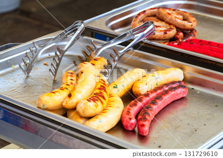Closeup shot of sausages on the metal tray 131729610