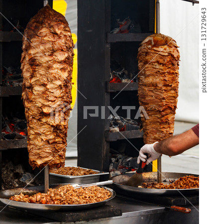 Closeup picture of stacked meat roasting, shawarma Closeup picture of stacked meat roasting, shawarma 131729643