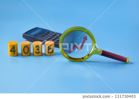 Business concept meaning 403b,Magnifier glass with calculator. Business concept meaning 403b,Magnifier glass with calculator. 131730403