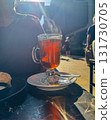 Hot Tea in Glass Cup with Steam in Sunlight 131730705