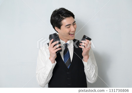 A man holding a camera lens and worrying 131730806