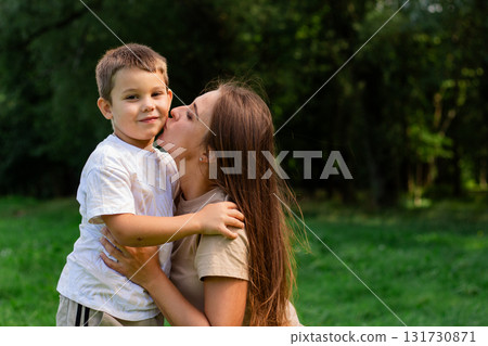 Image of happy mother and son outside in public park. Ideal for themes of parenting, motherhood and family relationships 131730871