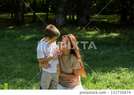 Close up of mother and son exchanging loving whispers and giggles. Perfect illustration of secure attachment and childhood happiness. 131730874