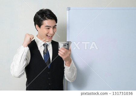 A man who is pleased to see a smartphone A man who is pleased to see a smartphone 131731036