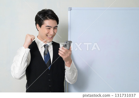 A man who is pleased to see a smartphone A man who is pleased to see a smartphone 131731037