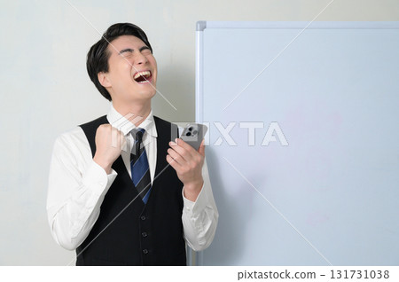 A man who is pleased to see a smartphone A man who is pleased to see a smartphone 131731038