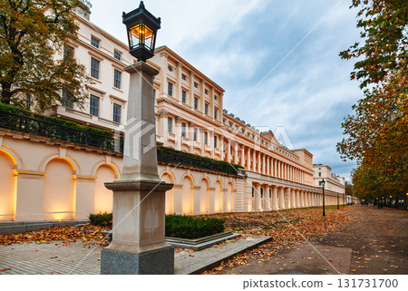 Elegant neoclassical building with illuminated facade and autumn trees in London 131731700