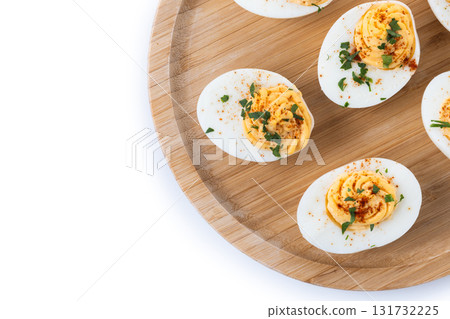 Homemade hard Boiled Deviled Eggs garnished with herbs 131732225