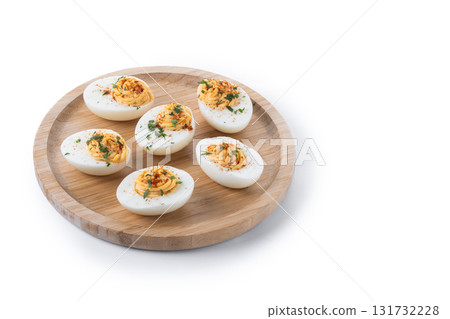 Homemade hard Boiled Deviled Eggs garnished with herbs 131732228