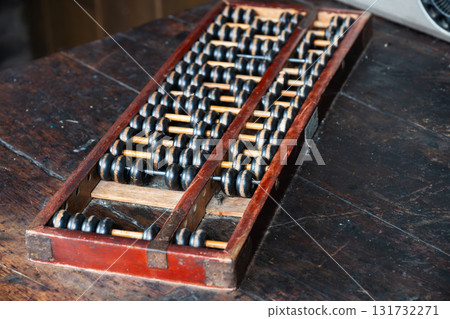 Vintage abacus resting on a wooden table Vintage abacus resting on a wooden table 131732271