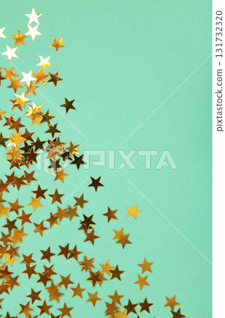 Golden glitter stars on mint background. Vertical photo Golden glitter stars on mint background. Vertical photo 131732320