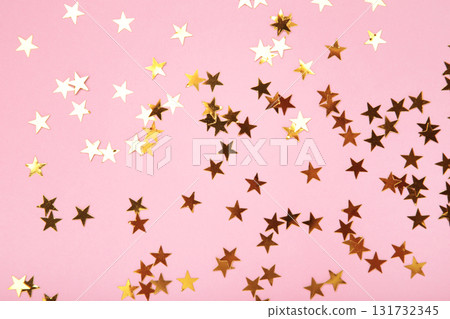 Golden glitter stars on pink background Golden glitter stars on pink background 131732345