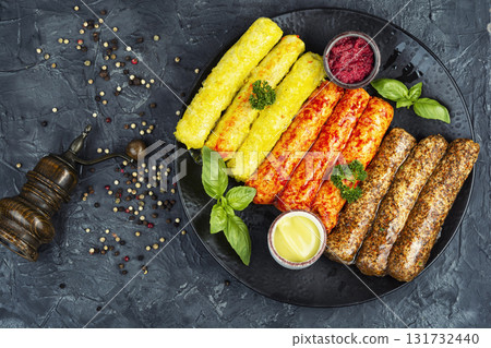 Raw grilled sausages and ingredients cooking. Raw grilled sausages and ingredients cooking. 131732440