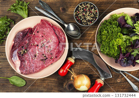 Raw cuts of meat, beef on rustic table. Raw cuts of meat, beef on rustic table. 131732444