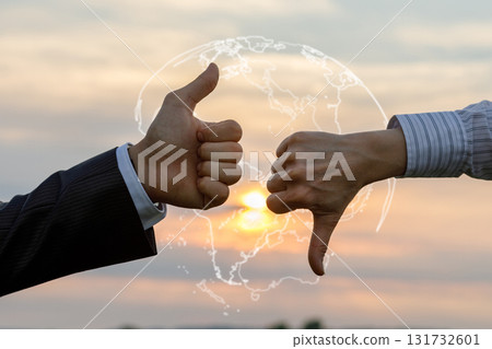 Hands expressing approval and disapproval at sunset. 131732601