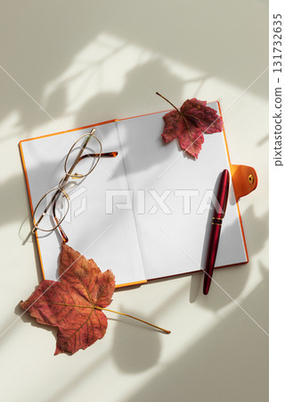 Autumn Flat Lay with Notebook, Leaves and Eyeglasses Autumn Flat Lay with Notebook, Leaves and Eyeglasses 131732635