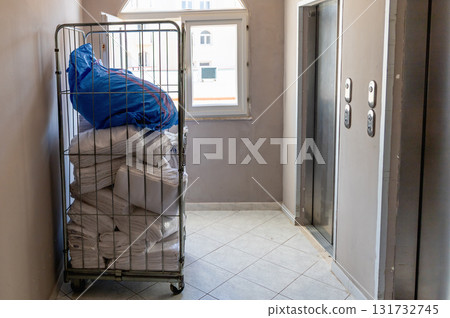 Service cart with fresh towels and sheets near elevator Service cart with fresh towels and sheets near elevator 131732745