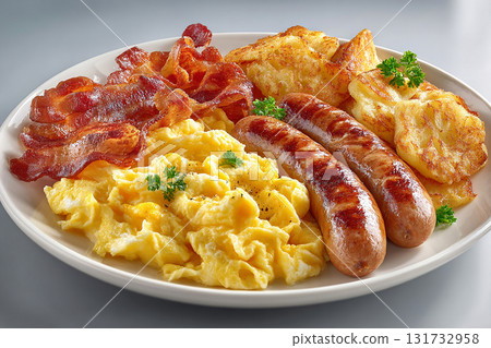 Breakfasts served in hotels. American buffet breakfast. Scrambled eggs, bacon, sausage and hash browns in plate on a white background. Traditional dish. 131732958