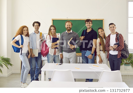 Group portrait of smiling and happy college students together with their favorite teacher. Group portrait of smiling and happy college students together with their favorite teacher. 131732977