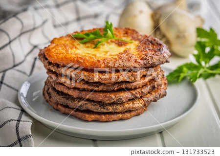 Fried potato pancakes on plate on white table. Fried potato pancakes on plate on white table. 131733523