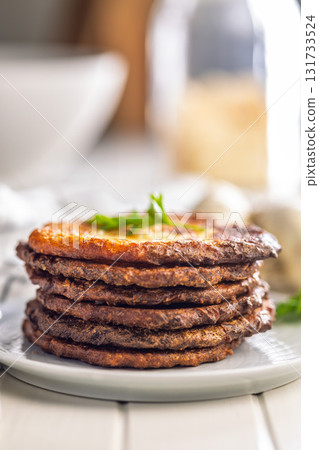 Fried potato pancakes on plate on white table. 131733524
