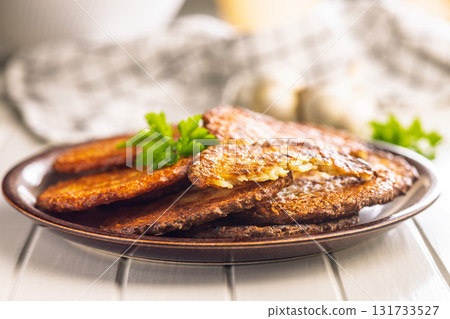 Fried potato pancakes on plate on white table. Fried potato pancakes on plate on white table. 131733527