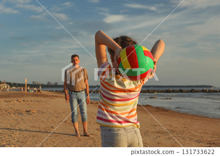 Girl swung at her dad to throw ball on beach 131733622