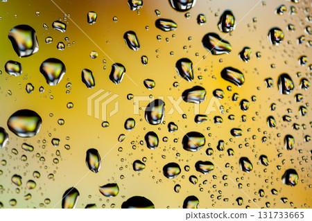 Beautiful multi-colored water droplets on a glass Beautiful multi-colored water droplets on a glass 131733665