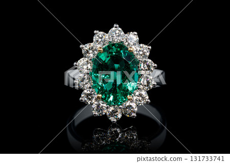 silver or gold ring with emerald stone and diamonds on black background silver or gold ring with emerald stone and diamonds on black background 131733741