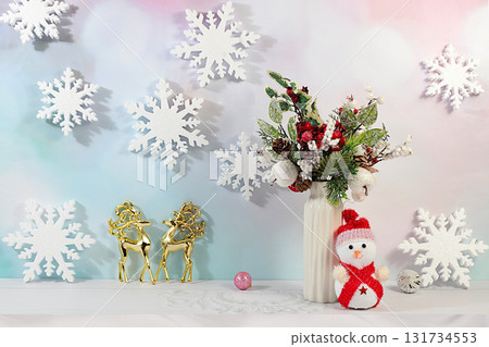 Christmas Eve concept. Christmas and New Year's mockup for product design and display featuring deer and a snowman, a creative Christmas bouquet of live fir branches and decorations 131734553