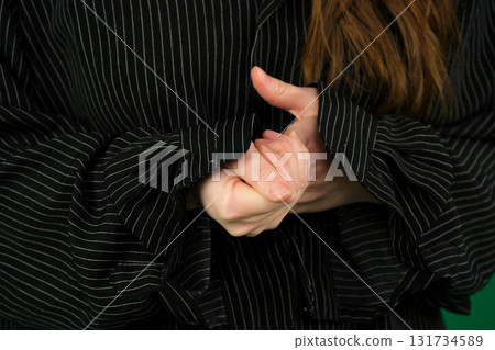 Set of videos featuring female hands of young European woman making different gestures on green chroma key background showing folded hands open palms and clenched fingers with copy space 131734589