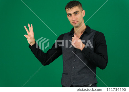 Set of videos with handsome European businessman in classic suit vest and black shirt showing different emotions gestures and confident poses on green chroma key background with copy space 131734590