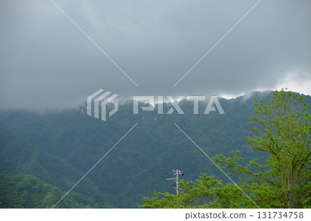 Rain clouds hanging over the mountaintop 05 131734758