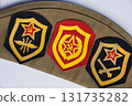 Russian military cap with patches. Green cap and three Soviet era patches with hammer and sickle on ruby stars. High quality photo 131735282