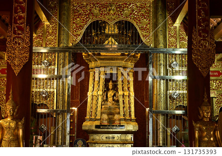 The statue of Phra Chao Pantan Buddha is enshrined in a teakwood chapel at Wat Den Sali Si Mueang Kaen temple or Wat Ban Den. Located at Chiang Mai Province in Thailand. The statue of Phra Chao Pantan Buddha is enshrined in a teakwood chapel at Wat Den Sali Si Mueang Kaen temple or Wat Ban Den. Located at Chiang Mai Province in Thailand. 131735393
