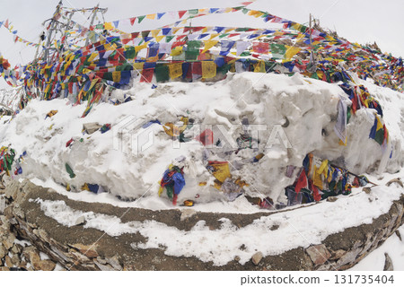 Prayer flags at a small religious site at Khardung La. This pass is located in the Ladakh mountains north of Leh and connects the Indus and Shyok river valleys and is the highest motorable road. Prayer flags at a small religious site at Khardung La. This pass is located in the Ladakh mountains north of Leh and connects the Indus and Shyok river valleys and is the highest motorable road. 131735404