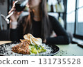 woman drink wine or eat caesar salad with grilled chicken, romaine and crouton 131735528