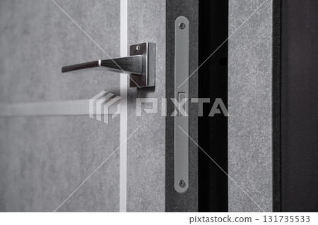 modern and secured metal door handle and latch detail 131735533