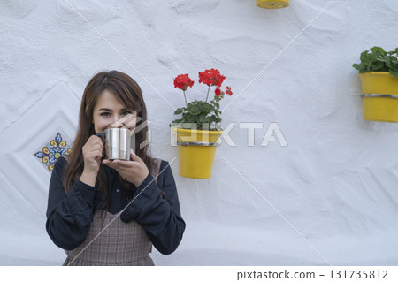 Young woman drinking coffee 131735812