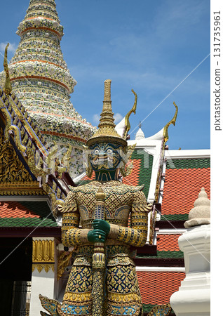 The large giant guardian standing guard at Wat Phra Kaew Temple of the Emerald Buddha is a famous tourist attraction. Bangkok capital city in Thailand. The large giant guardian standing guard at Wat Phra Kaew Temple of the Emerald Buddha is a famous tourist attraction. Bangkok capital city in Thailand. 131735961