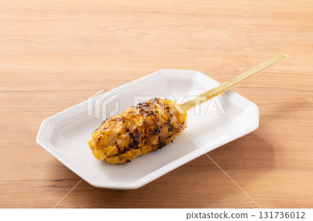 Deep-fried kamaboko and grilled corn skewers 131736012