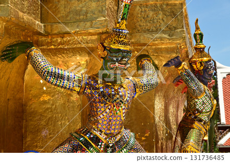 The large giant guardian standing guard carrying the pagoda base at Wat Phra Kaew Temple of the Emerald Buddha is a famous tourist attraction. Bangkok Thailand. 131736485