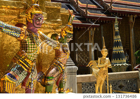 The large giant guardian standing guard carrying the pagoda base at Wat Phra Kaew Temple of the Emerald Buddha is a famous tourist attraction. Bangkok Thailand. The large giant guardian standing guard carrying the pagoda base at Wat Phra Kaew Temple of the Emerald Buddha is a famous tourist attraction. Bangkok Thailand. 131736486